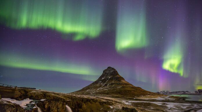 Winter landscape in Iceland with the Northern Lights dancing in the sky