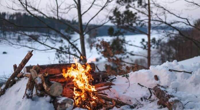Campfire on snow during camping trip in Iceland